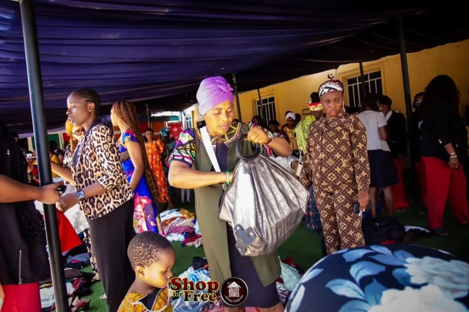 A beneficiary receiving practical clothing support at the outreach
